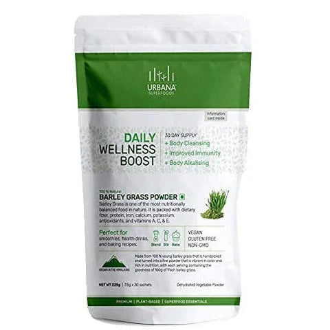 An image depicting Urbana Superfoods Daily Wellness Boost Barley Grass Powder pouch. The white and green pack highlights benefits such as body cleansing, improved immunity, and body alkalising. Labels mention vegan, gluten-free, and non-GMO products perfect for smoothies, health drinks, and baking recipes.