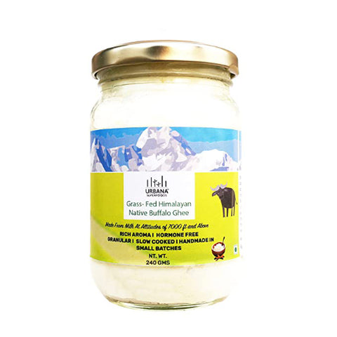 An image depicting a glass jar of Urbana Superfoods Grass-Fed Himalayan Native Buffalo Ghee, showing creamy white texture with Himalayan mountain illustration and a buffalo icon, symbolising purity, high-altitude sourcing, and traditional handmade ghee.