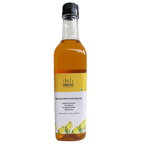 An image depicting a bottle of Urbana Superfoods Brown Seed Mustard Oil from the Pantry Essentials collection, showcasing pure cold-pressed oil in a transparent glass bottle with a yellow label, symbolising traditional cooking, natural aroma, and handcrafted quality.