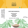 An image depicting a bottle of Urbana Superfoods White Seed Sesame Oil, filled with golden cold-pressed oil, featuring a clean yellow label with sesame illustrations, representing purity, nutrition, and handcrafted extraction.