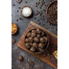 An image depicting a brown pack of Urbana Superfoods Truepops Coffee & Cocoa Superfood Energy Balls placed beside chocolate-coated energy balls, representing rich flavour, energy boost, and natural ingredients.

